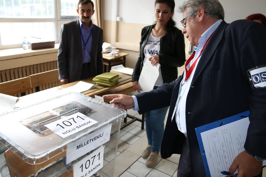 OSCE PA Delegation head Ignacio Sanchez Amor (MP, Spain) checks the seal on a ballot box at the opening of a polling station, Ankara, 7 June.